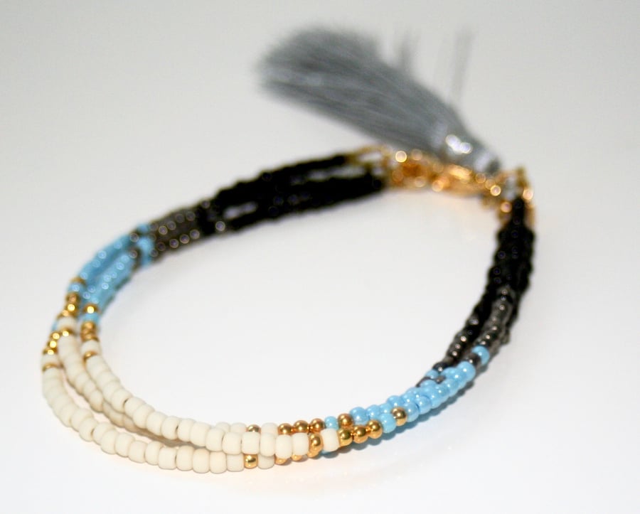 Multi-strand beaded tassel bracelet, blue and black