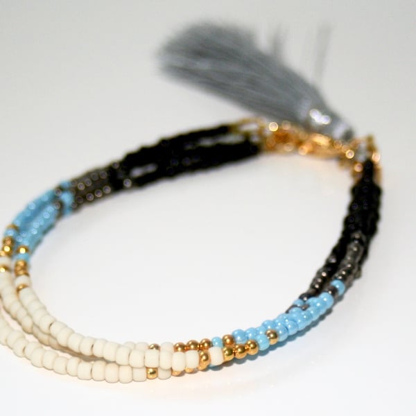 Multi-strand beaded tassel bracelet, blue and black