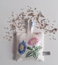 Upcycled linen lavender bag with a pair of vintage embroidered flowers