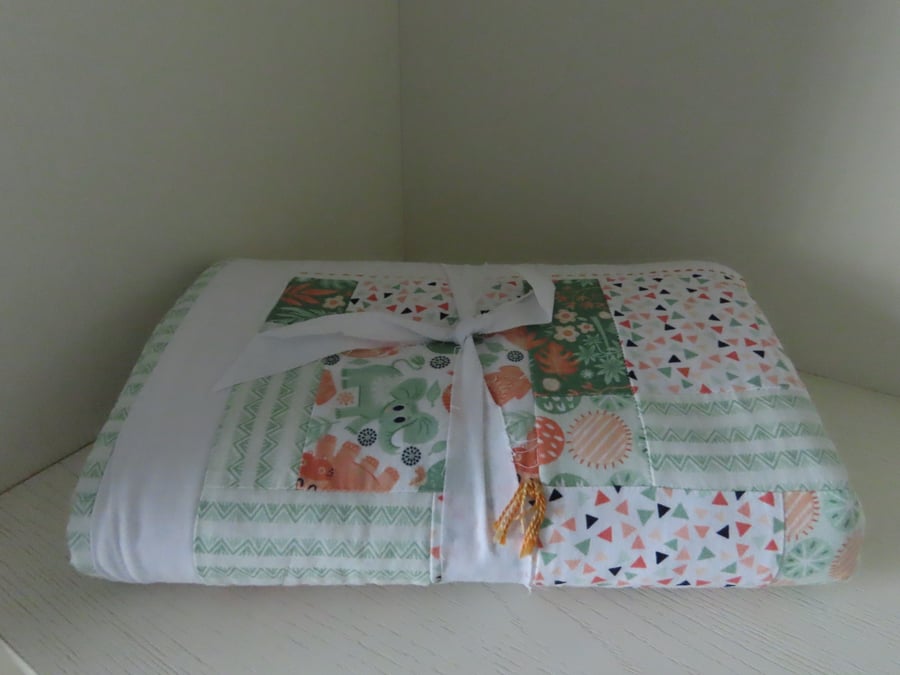 Handmade, quilted baby blanket for the nursery.