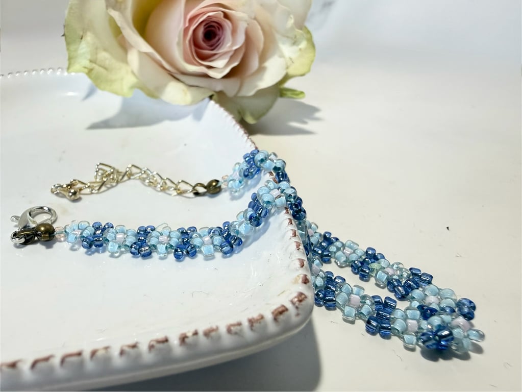 Blue daisy chain bracelet with lobster clasp.