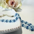 Blue daisy chain bracelet with lobster clasp.