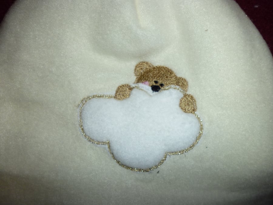 Hand made sewn baby hat in soft fleece fabric -cream with bear image