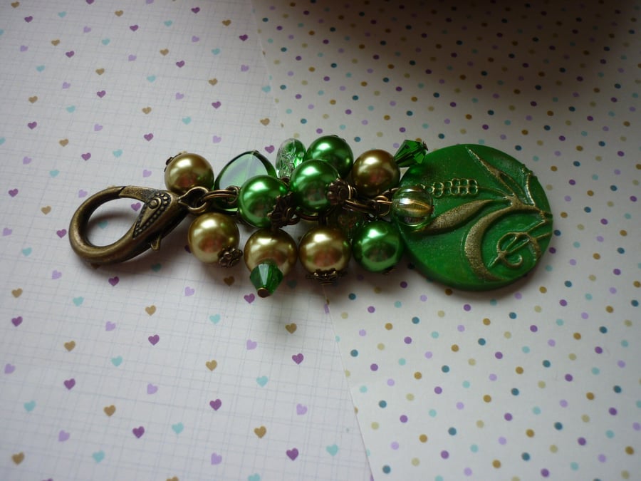 GREEN AND ANTIQUE BRONZE BAG CHARM.  