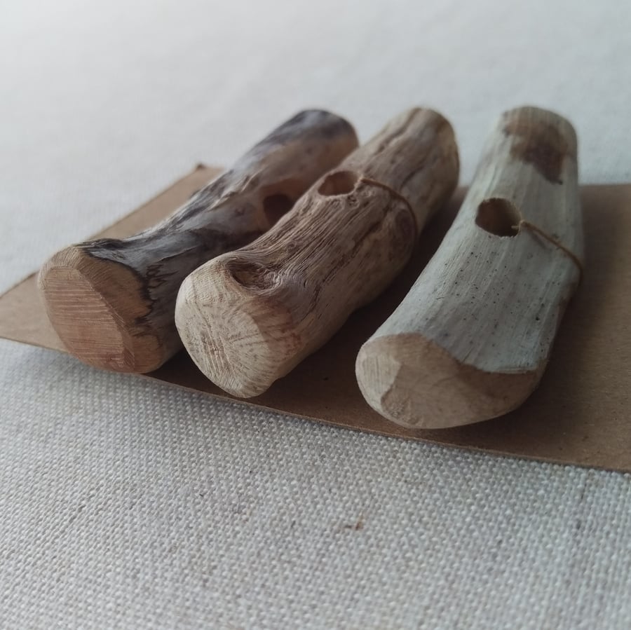 Set of three mismatched driftwood toggle buttons.