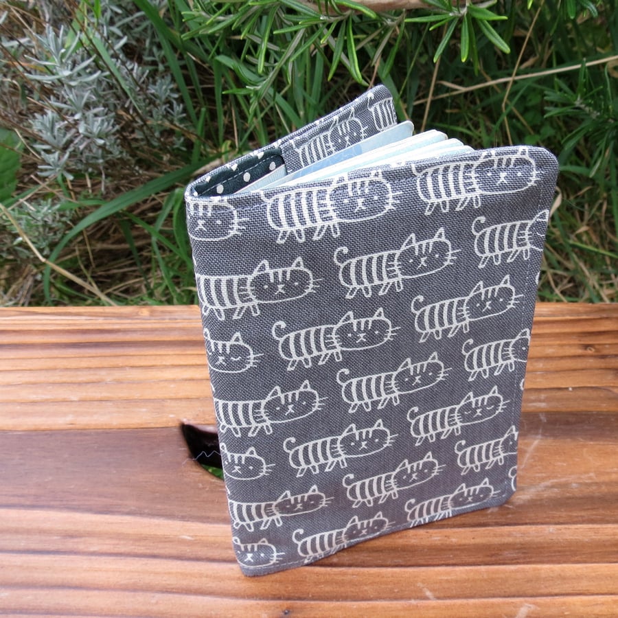 Cats.  A fabric passport sleeve wit a whimsical cats design.