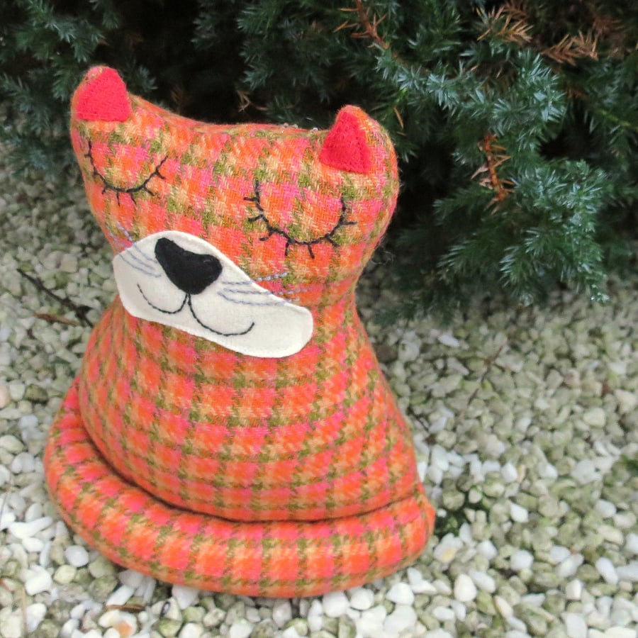 Marmalade,  a tweed cat doorstop.