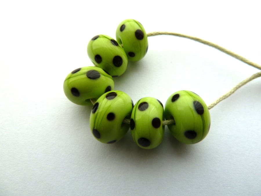 green and black lampwork beads