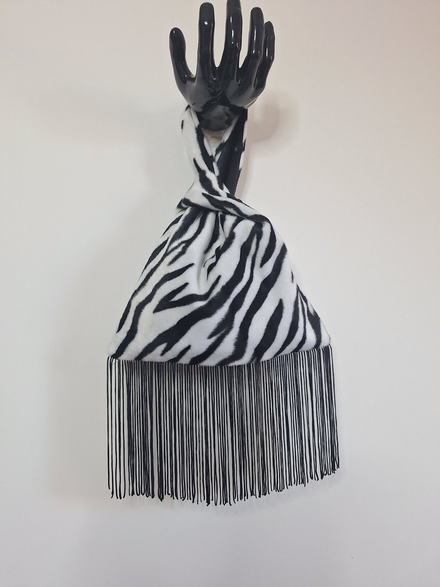 Image of  Animal print faux fur fabric Japanese Knot bag with 13cm black tassel trim 