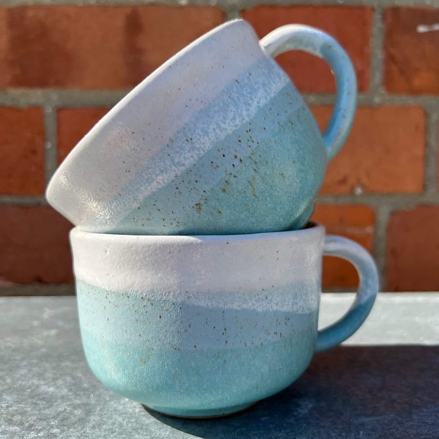 Hand made pottery mug in turquoise, green and white. 