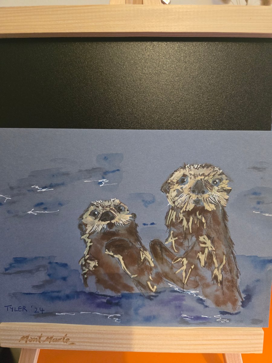 Otters frolicking on A5 paper 