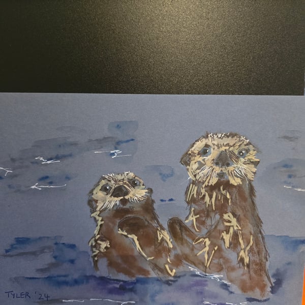 Otters frolicking on A5 paper 