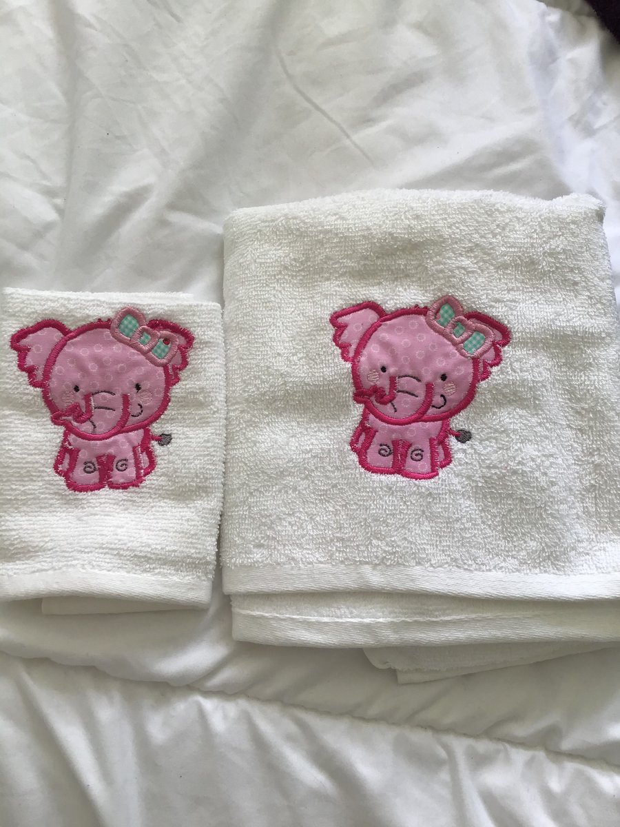 Towel and flannel set in white with pink elephant.