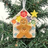 Ceramic gingerbread house decoration with snowy roof