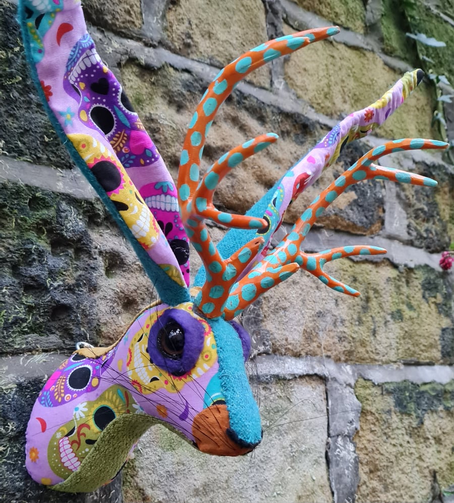 Faux jackalope head wall mount in Day of the Dead skull style fabric