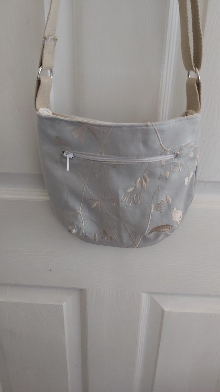 Silver floral patterned bag crossbody or shoulder.