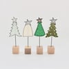 A Christmas Tree with a Wire Stem and Wooden Block Stand
