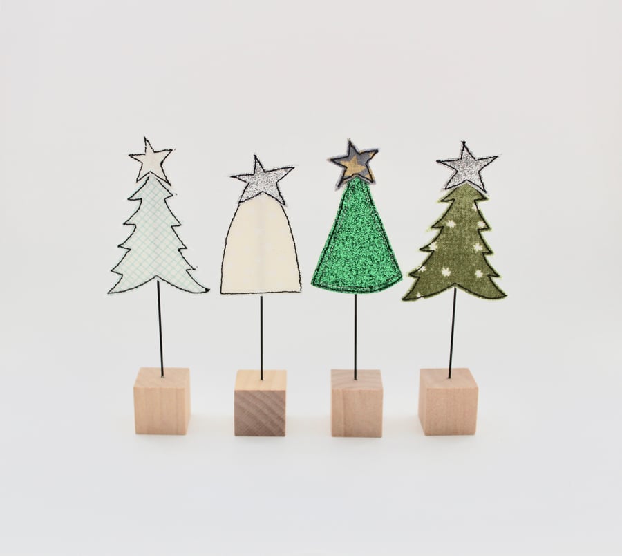 A Christmas Tree with a Wire Stem and Wooden Block Stand