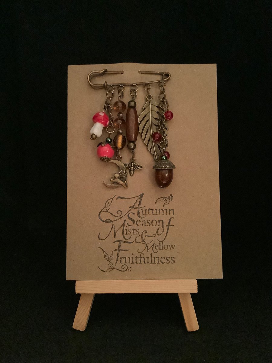 Handmade Autumn themed kilt pin brooch attached to a kraft greetings card.