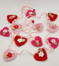 Crochet Hearts  and Flowers Mini Bunting in Pinks and Red - Image 1