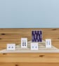 Triangular Corner Display Stand with Grooves for Cards and Jewellery in Retail - Image 1