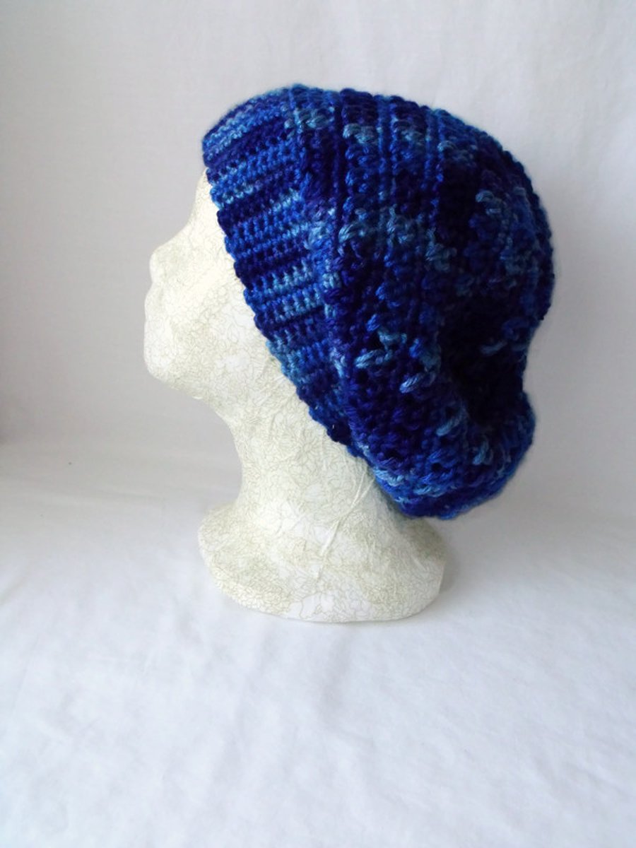 blue crocheted slouchie beanie hat with criss cross stitches