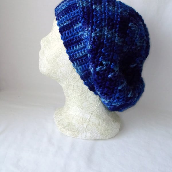 blue crocheted slouchie beanie hat with criss cross stitches