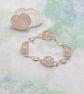 Twisted rose quartz nugget bracelet with wire spiral charms - Image 1