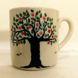 Mug in pottery stoneware with apple tree design. 