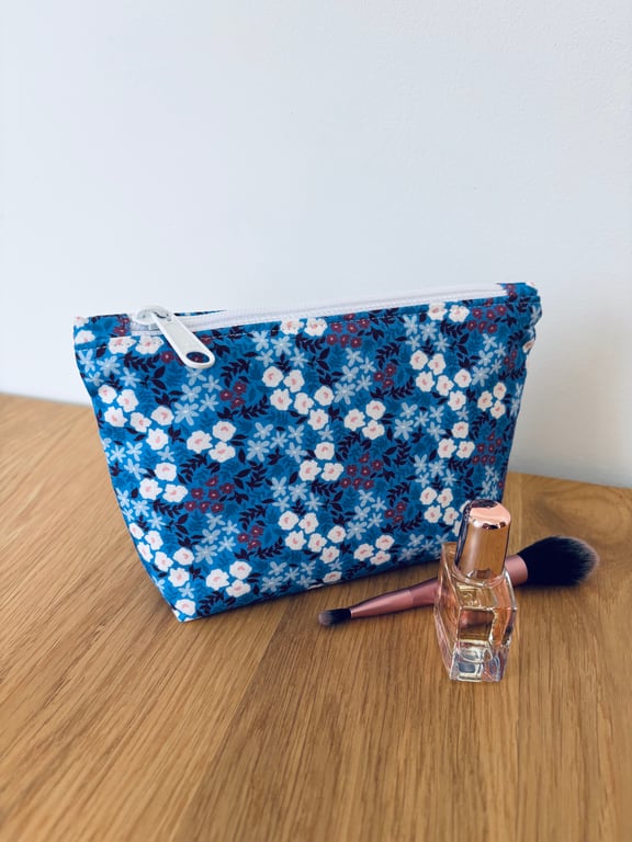 Small cotton makeup bag, pouch, purse, in blue and purple floral design.