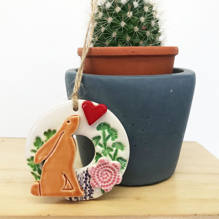 Small ceramic hare decoration with summer flowers