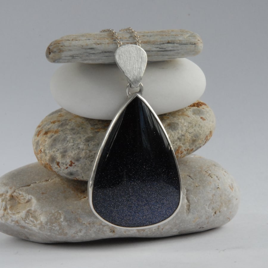 Large pear shaped navy blue goldstone and sterling silver pendant