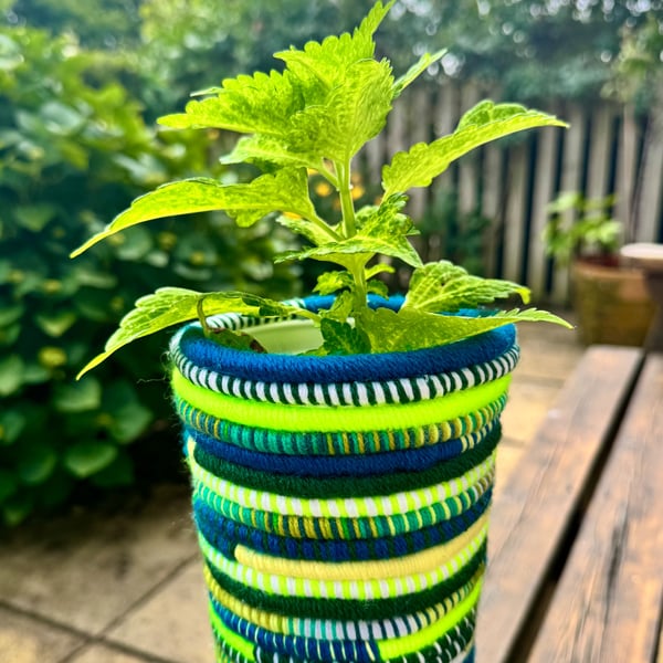 Boho planter in shades of green. Recycled yoghurt pot and yarn.