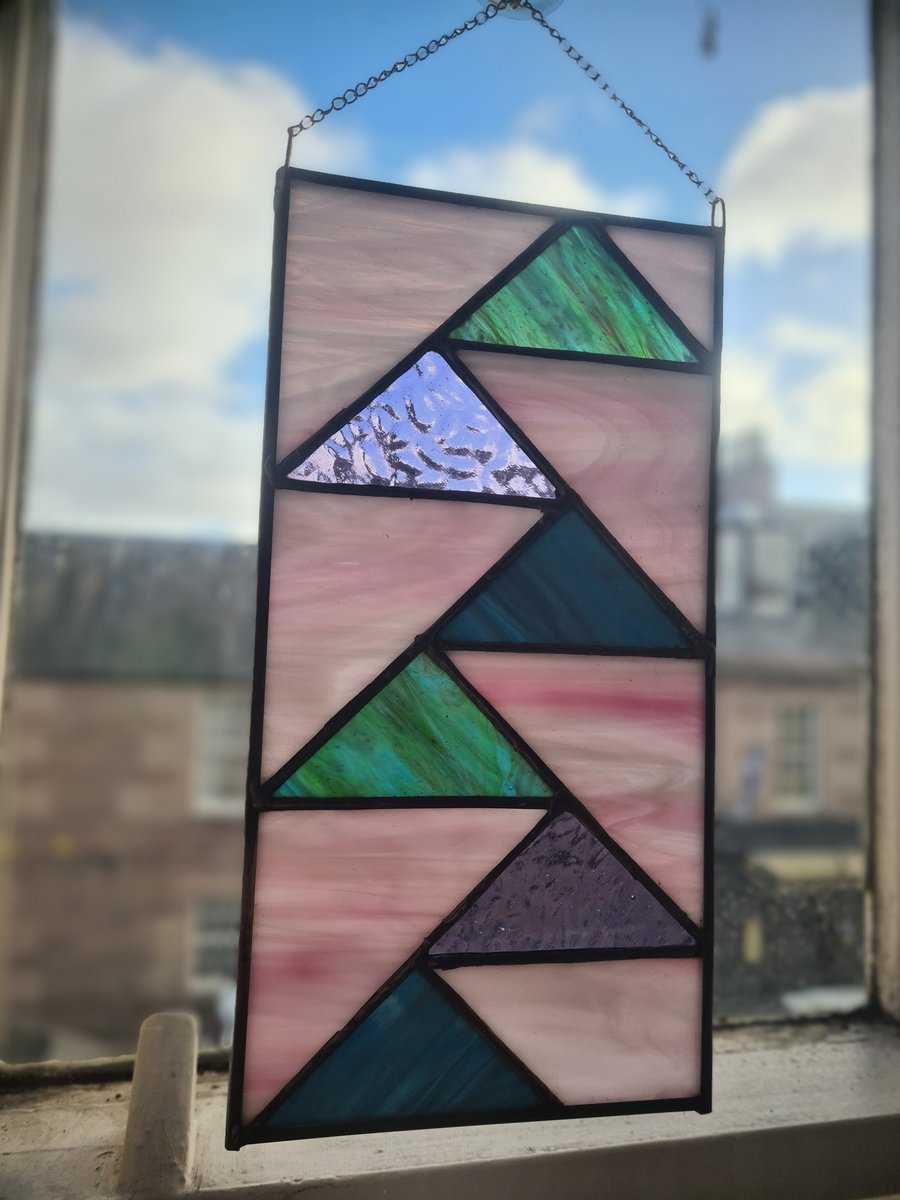 Stained glass flying geese in pink