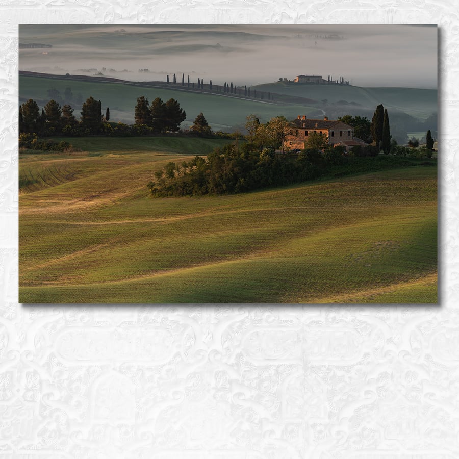 Early morning light on a Tuscan villa with mist shrouded hills