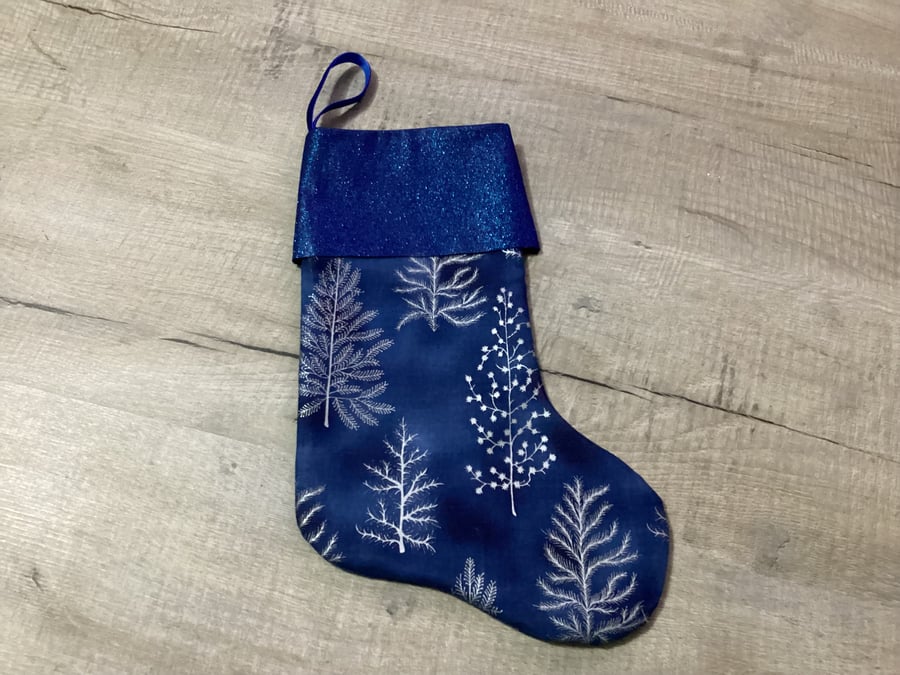 Christmas stocking , blue and silver, Christmas tree.