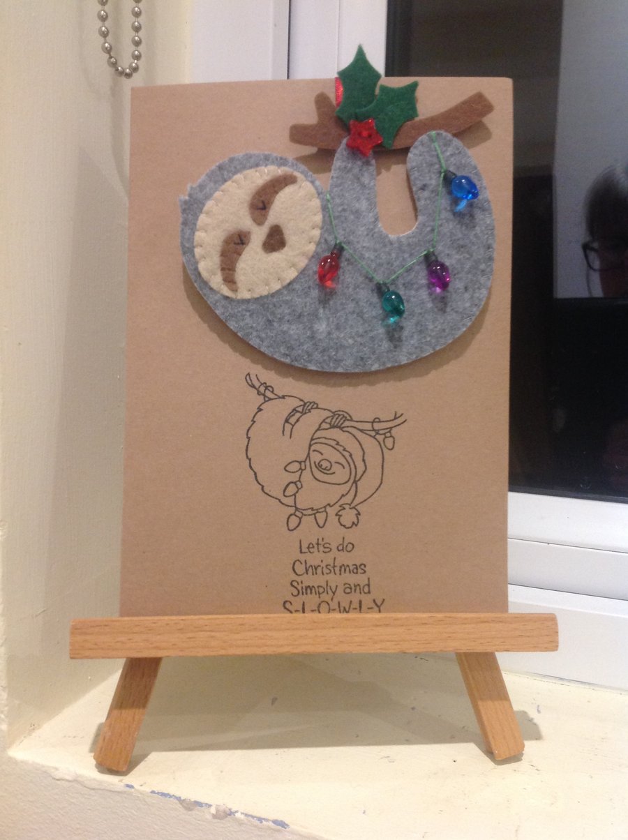 Handmade felt sloth decoration attached to card with envelope.