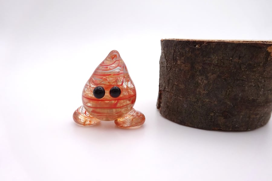 small red wispy glass wisp figure