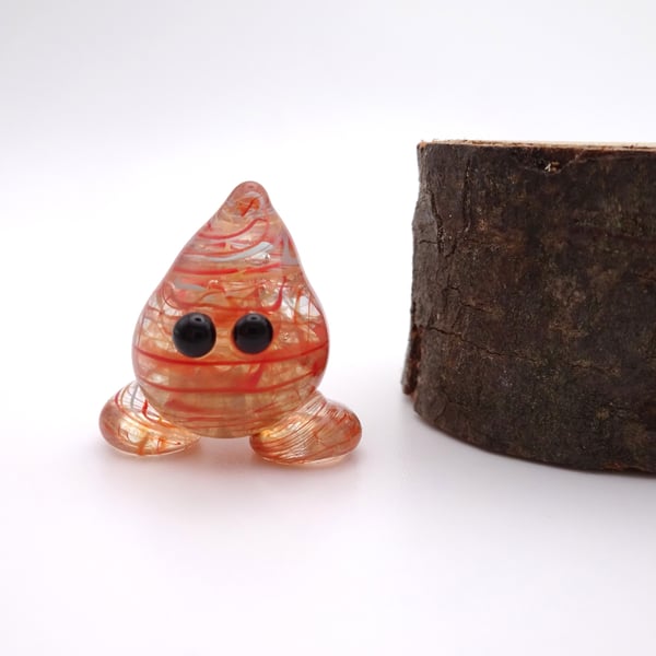small red wispy glass wisp figure
