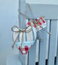 Pair hanging heart decorations on a seaside theme - Image 2