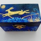 A little wooden trinket box hand paiinted  with a golden hare