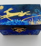  A little wooden trinket box hand paiinted  with a golden hare