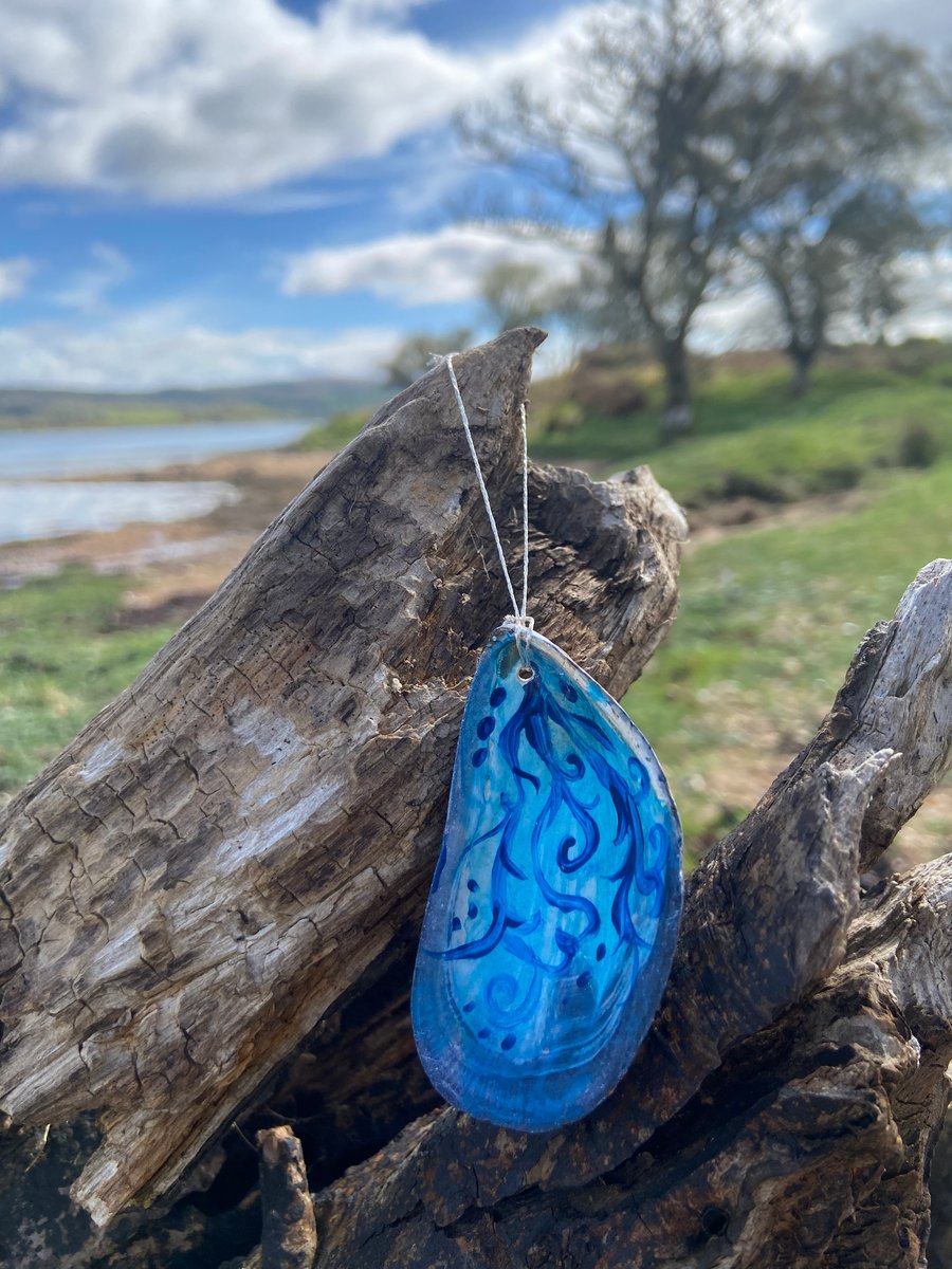 Hand painted mussel shell from an Argyll beach. With a beaded hanger.