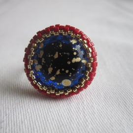 A Red and Gold Ring with a Blue and Gold Centre