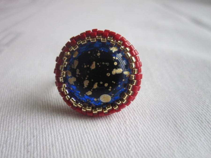 A Red and Gold Ring with a Blue and Gold Centre