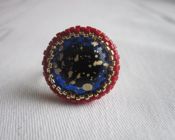 A Red and Gold Ring with a Blue and Gold Centre