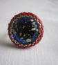 A Red and Gold Ring with a Blue and Gold Centre - Image 1