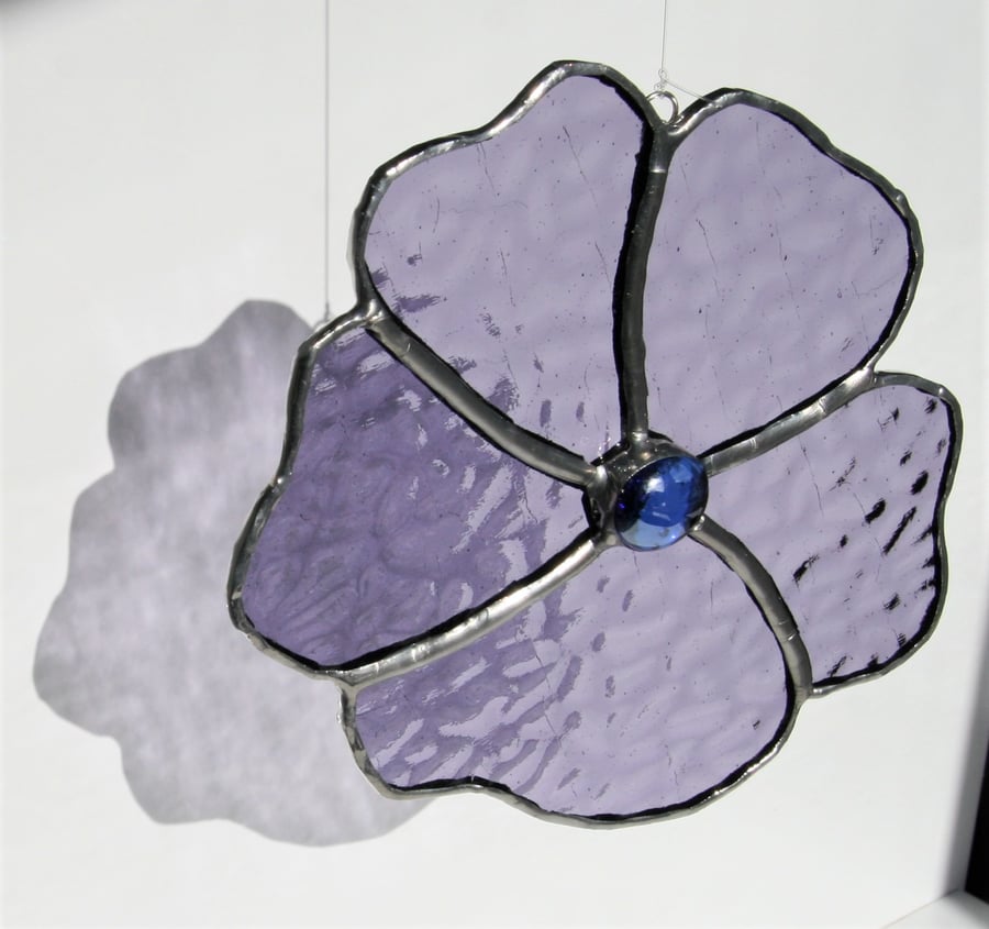 Handmade flower made with a lilac purple stained glass.