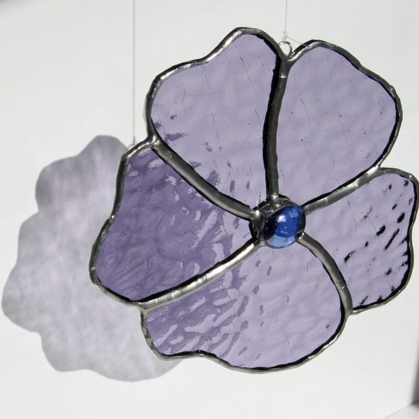 Handmade flower made with a lilac purple stained glass.