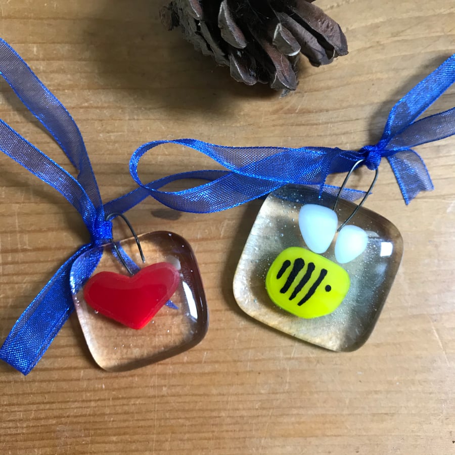 Small fused glass sun catchers of bee and heart.